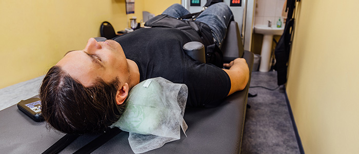 man laying on a spinal decompression table